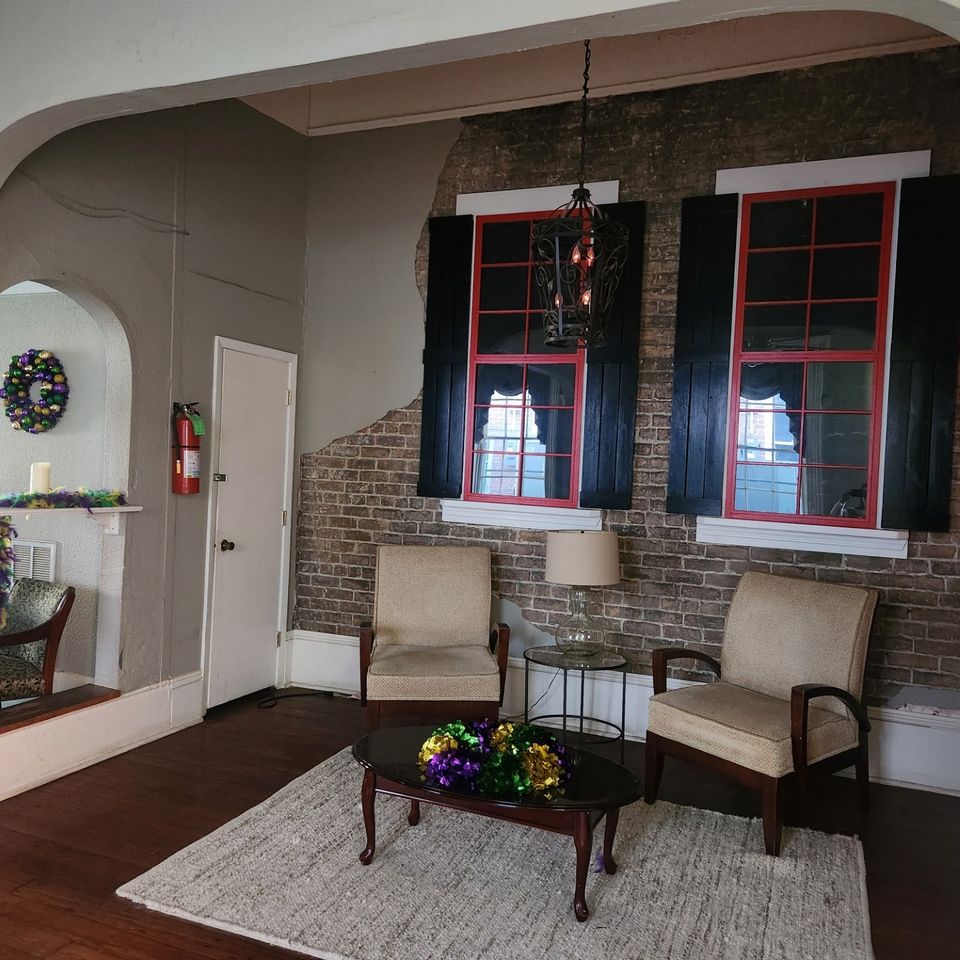More seating at 232 Bourbon Street balcony, two chairs and a table.