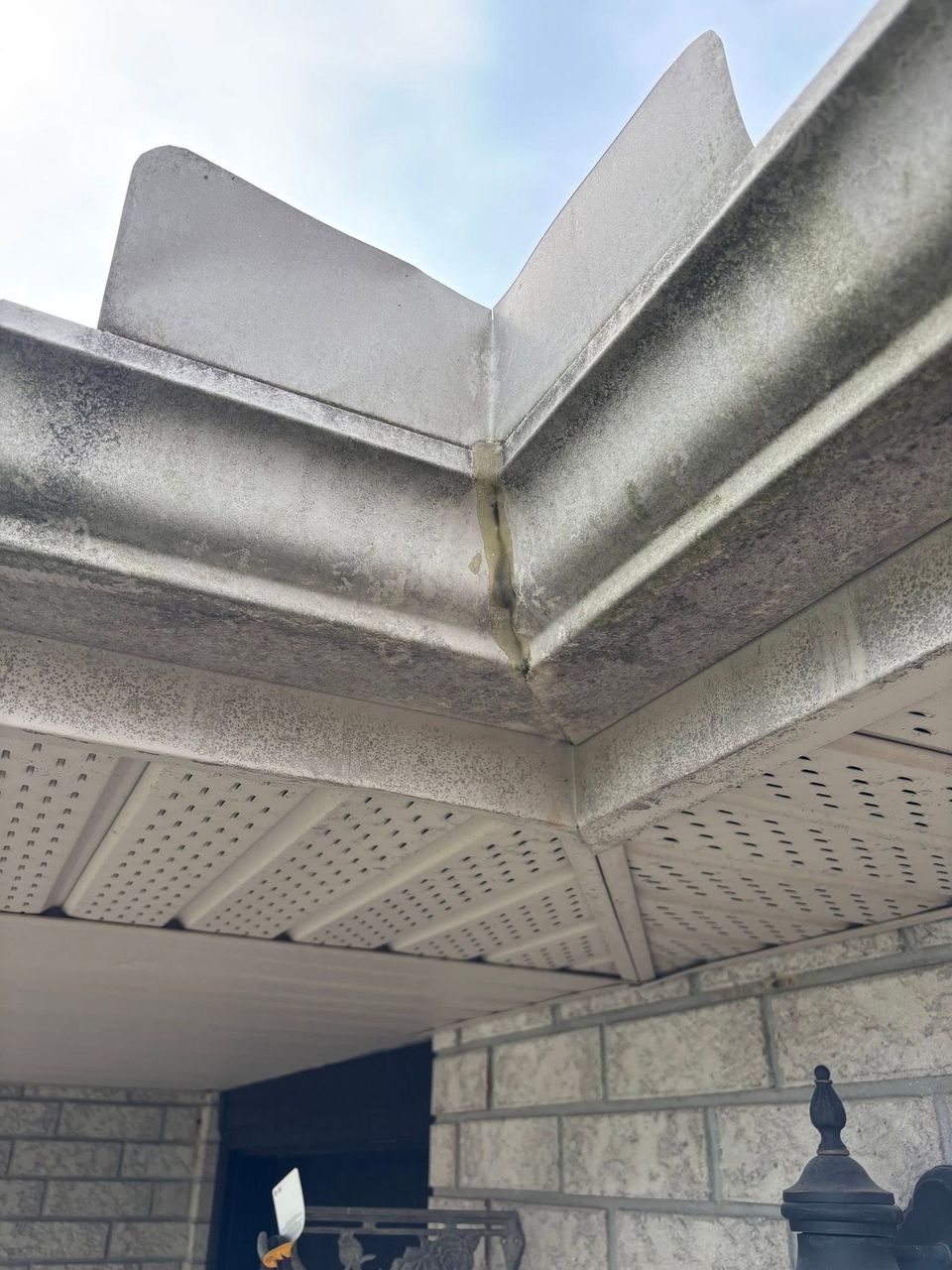 Dirty gutter exterior streaked with algae before gutter brightening on a Tillsonburg Ontario home