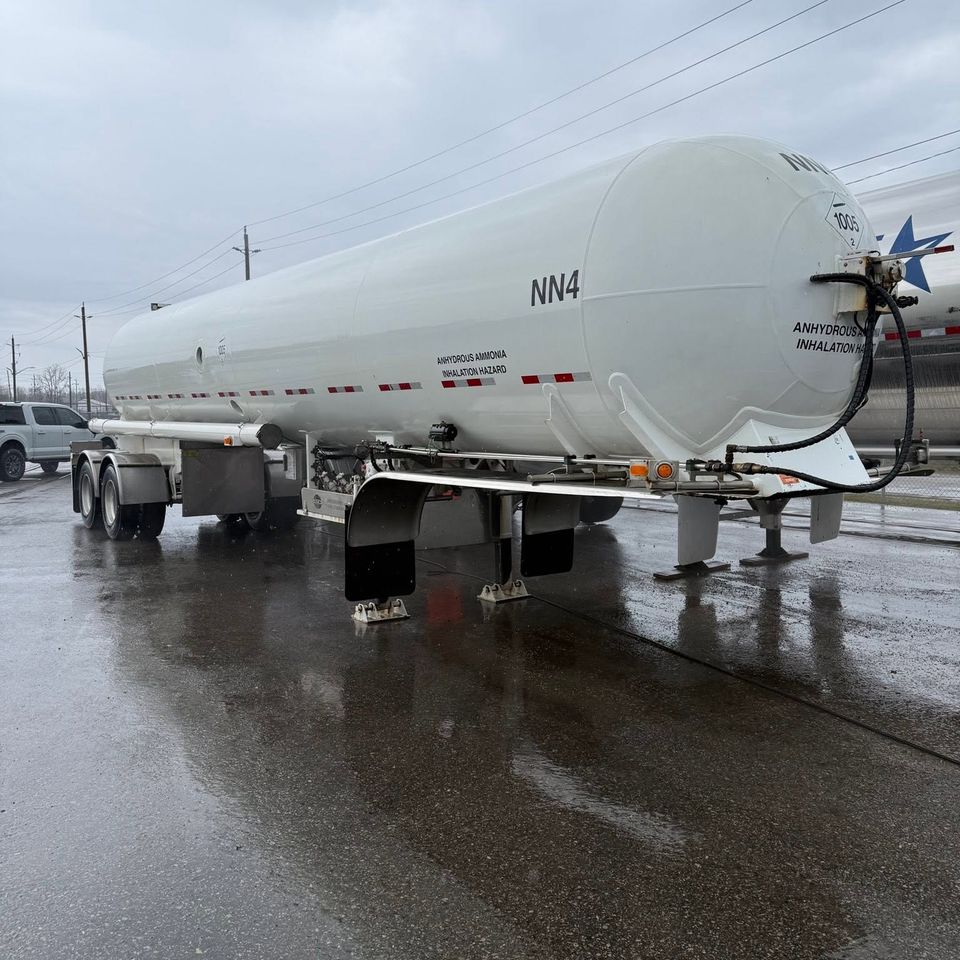 Freshly pressure washed white tanker trailer on wet industrial lot for commercial cleaning in Tillsonburg ON
