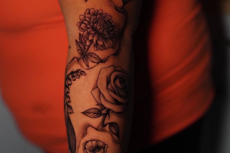 Image of a tattoo that covers from the shoulder to the wrist with space in between the individual tattoos.