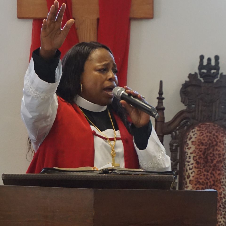 Andrea preaching in front of the cross