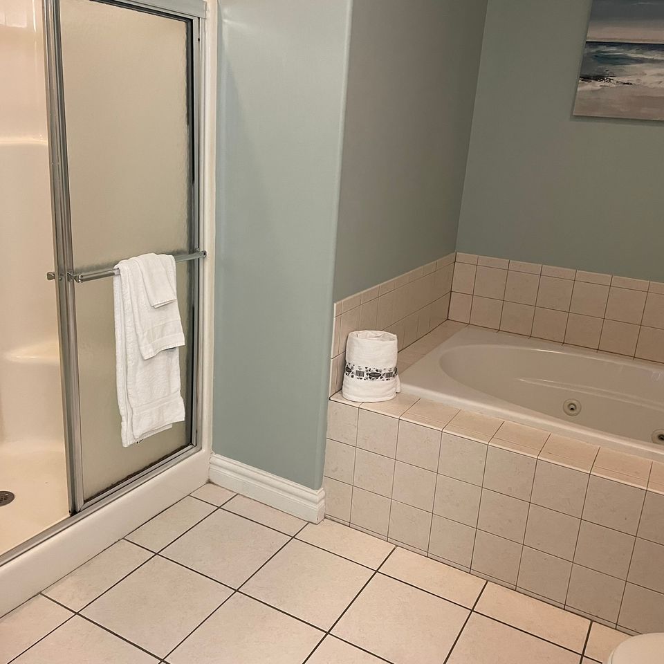 Spotless walk in shower and tiled tub after house cleaning service in Virginia Beach VA