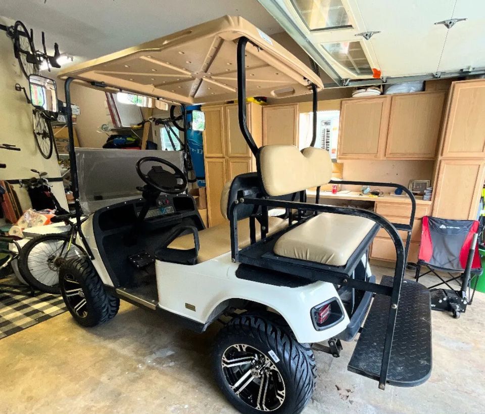 Golf cart in garage promoting free 7-point inspection by Neighborhood Golf Carts in Metairie, LA