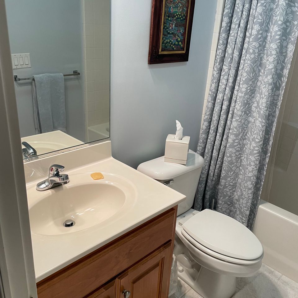 Clean compact bathroom with polished sink and toilet after a house cleaning service in Virginia Beach VA