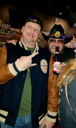 Two event attendees posing together and enjoying the festive atmosphere at a holiday celebration.