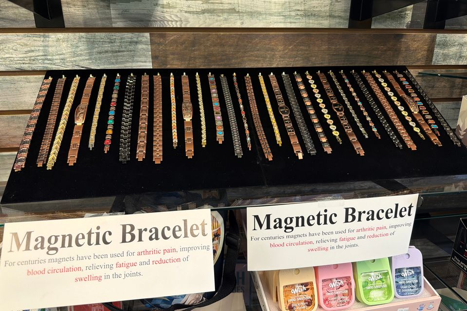 Sleek magnetic therapy bracelet displayed on a colorful counter at Yum Yum Vape Shop.