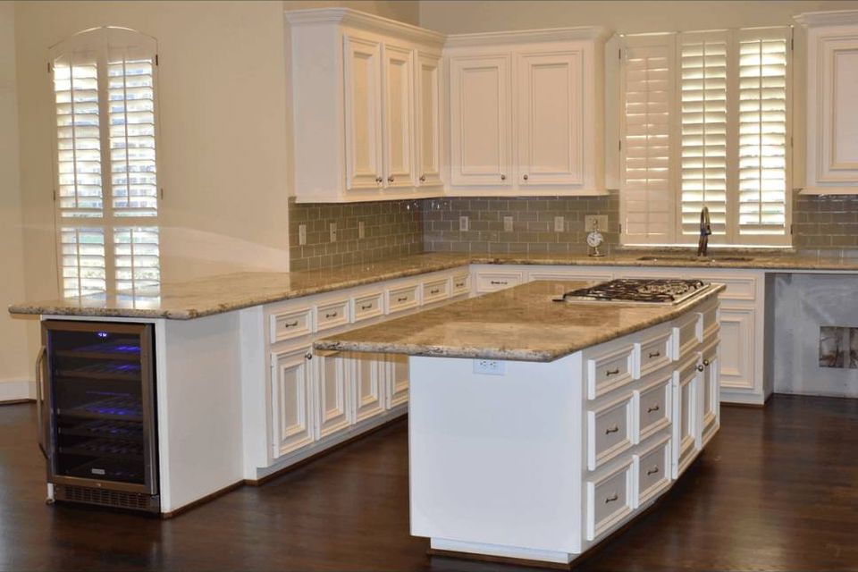 Completed kitchen remodel with large island, custom cabinetry, and stone countertops in Spring TX