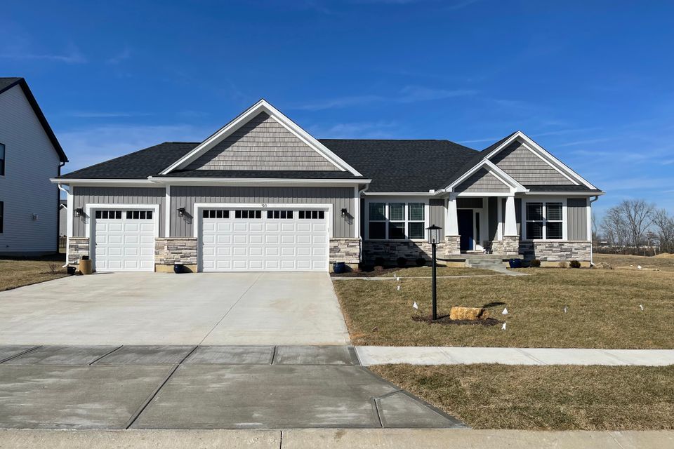 Gray ranch-style home with a professionally installed architectural asphalt shingle roof by E & D Roofing, Inc.