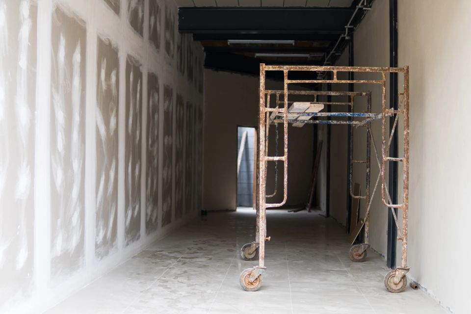 A drywall project with scaffolding next to it