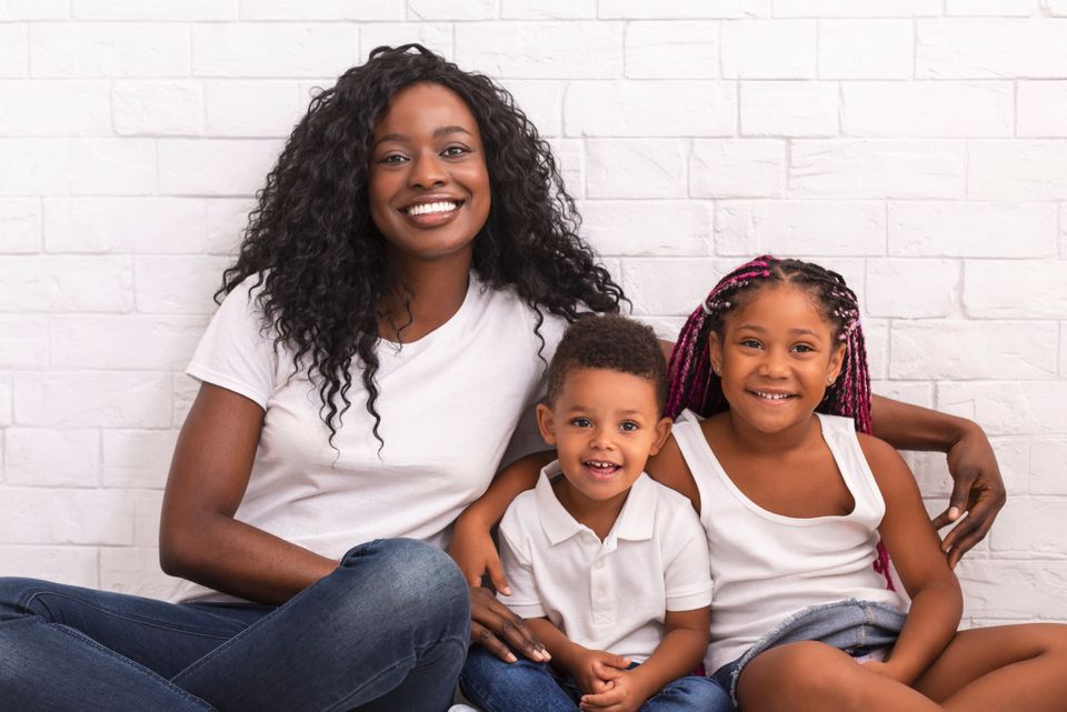 Young african mother with her children sitting tog 2023 11 27 05 30 36 utc