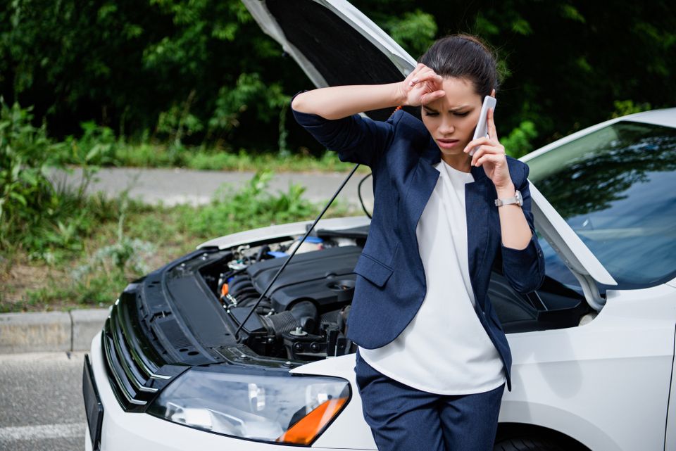 Stranded woman needing auto repair services depositphotos 203802170 l