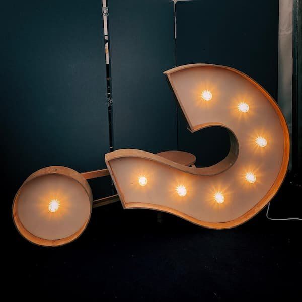 A lit up Question mark on its side 