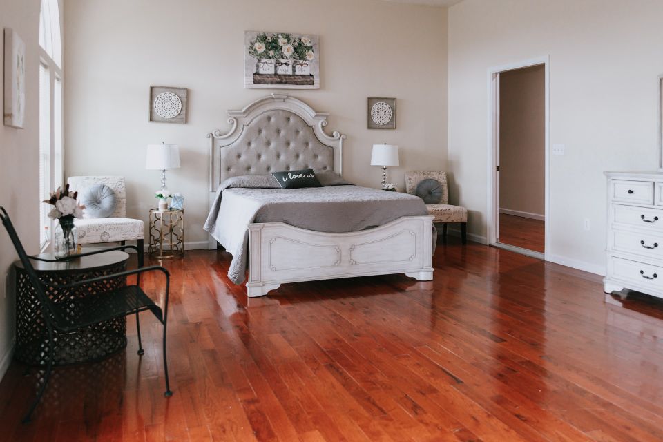 A bedroom in a residential home with hardwood floors
