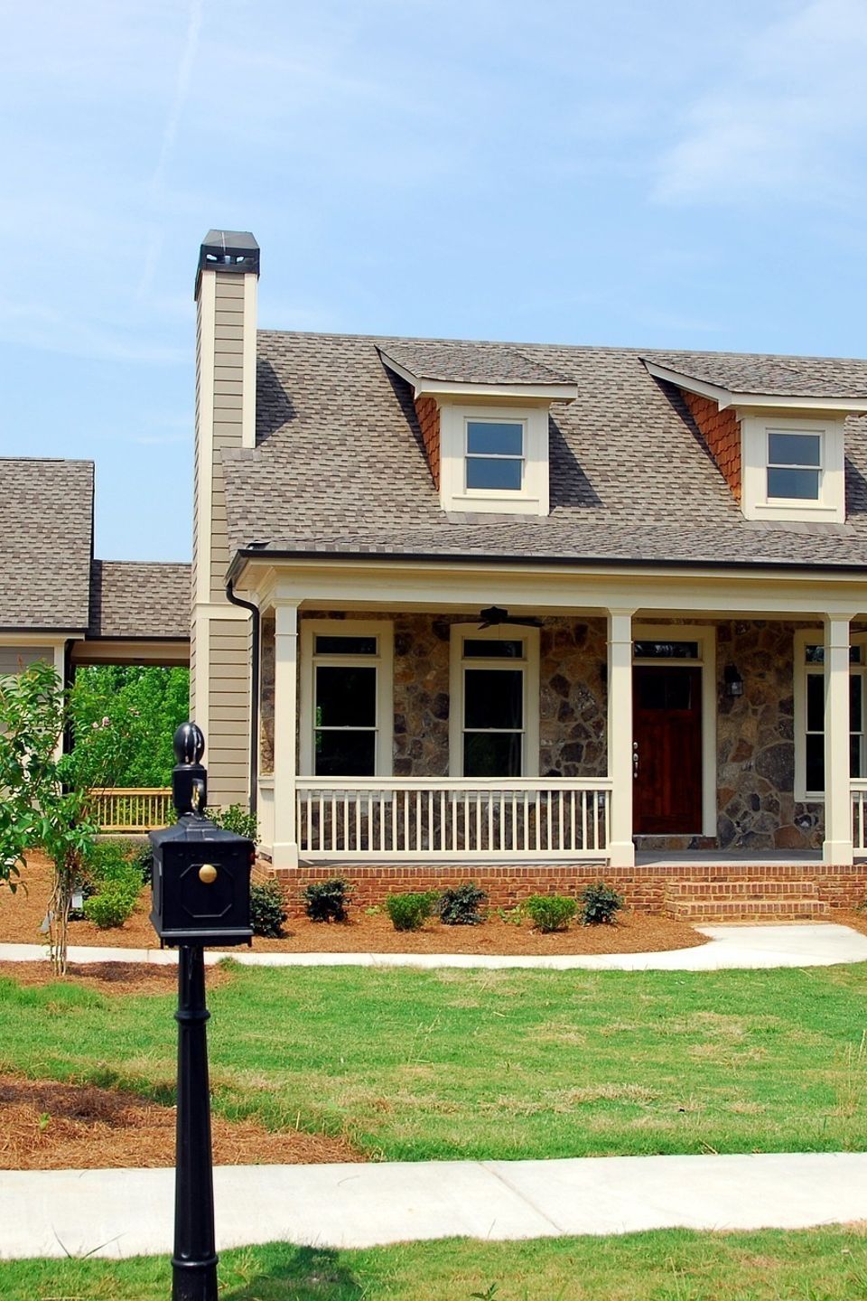 A beautiful North Carolina [Architectural Style, e.g., Craftsman or Modern Farmhouse] home featuring a spacious front porch, [Exterior Color, e.g., Boothbay Blue] siding, and professional [Roofing Material] installed by Nova Roofing + Construction LLC.