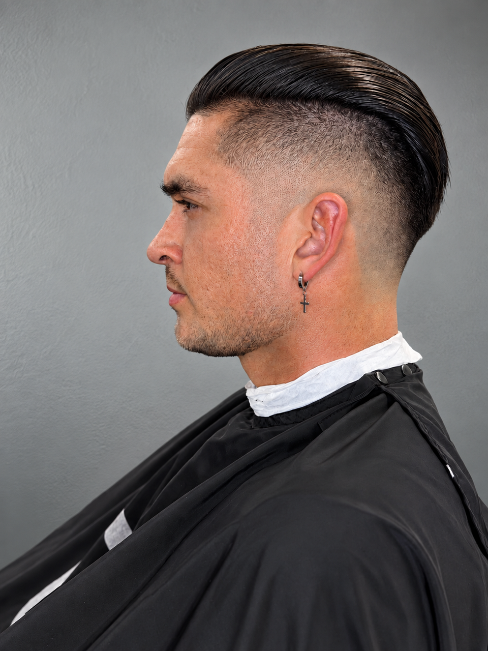 This image shows a man with a fade after a fresh haircut. 