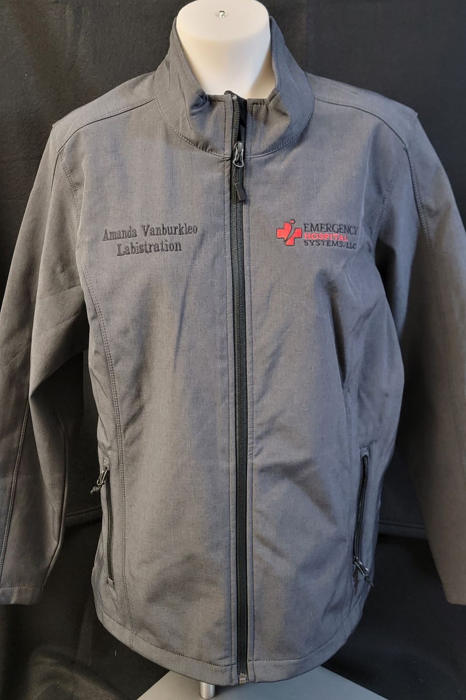 Embroidery Example - logo on gray windbreaker jacket. 