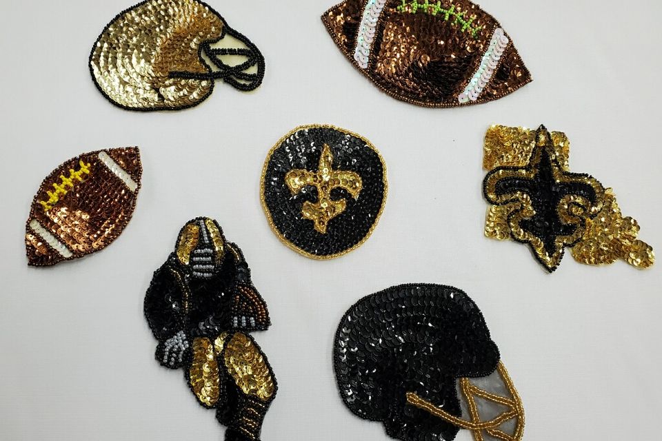 Assorted black and gold Saints themed appliques