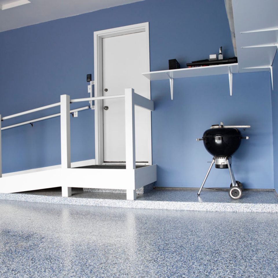 Garage featuring EverStone Flakes flooring with a raised entry platform.